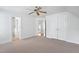 Bright bedroom showcasing neutral carpet, multiple closets and views of an entryway at 10405 Veasey Mill Rd, Raleigh, NC 27615