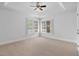 Bright bedroom boasting carpet floors, a tray ceiling and a window with shutter blinds at 10405 Veasey Mill Rd, Raleigh, NC 27615