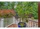 Multi-level deck showcases mature landscaping, white railing, and wood planking, creating a relaxing outdoor space at 10405 Veasey Mill Rd, Raleigh, NC 27615