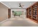 Open-concept game room features a pool table, built-in shelves, and a ceiling fan at 10405 Veasey Mill Rd, Raleigh, NC 27615