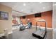 Home gym featuring exercise equipment, TV, a mirror, and rubber flooring for workouts at 10405 Veasey Mill Rd, Raleigh, NC 27615