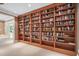 This room showcases a large wooden bookcase filled with books at 10405 Veasey Mill Rd, Raleigh, NC 27615