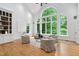 Living room with vaulted ceilings, hardwood floors and many windows overlooking backyard at 10405 Veasey Mill Rd, Raleigh, NC 27615
