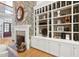 Close up of fireplace with stone accent and built-in shelving with decor at 10405 Veasey Mill Rd, Raleigh, NC 27615