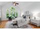Bright main bedroom with vaulted ceilings, a large arched window, and a seating area at 10405 Veasey Mill Rd, Raleigh, NC 27615