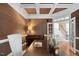 Cozy office space with a piano, hardwood floors, and a white chair near a window at 10405 Veasey Mill Rd, Raleigh, NC 27615