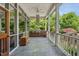Inviting screened porch features a built-in outdoor kitchen and slate flooring, perfect for entertaining at 10405 Veasey Mill Rd, Raleigh, NC 27615