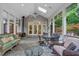 Cozy screened porch with dining and seating areas, wood-burning stove, and beautiful wooded views at 10405 Veasey Mill Rd, Raleigh, NC 27615