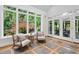 Bright sunroom with hardwood floors, large windows and tranquil views of the yard at 10405 Veasey Mill Rd, Raleigh, NC 27615