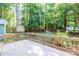 Wooden back deck with railings overlooking lush backyard surrounded by mature trees at 10816 Bent Branch Dr, Raleigh, NC 27603
