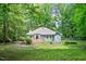 This home features a spacious backyard, mature trees, and a fenced garden at 10816 Bent Branch Dr, Raleigh, NC 27603