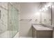 Modern bathroom with granite vanity, tub shower, and glass door at 10816 Bent Branch Dr, Raleigh, NC 27603