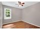 Comfortable bedroom with hardwood floors, a window and neutral paint, creating a tranquil atmosphere at 10816 Bent Branch Dr, Raleigh, NC 27603