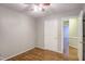 Cozy bedroom featuring gleaming hardwood floors, a ceiling fan, and an open doorway at 10816 Bent Branch Dr, Raleigh, NC 27603