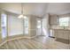 Cozy dining area with bright windows and a view of the kitchen and backyard entrance at 10816 Bent Branch Dr, Raleigh, NC 27603