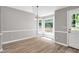 Bright dining area with large windows offering scenic views of the backyard deck and nature at 10816 Bent Branch Dr, Raleigh, NC 27603