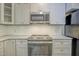 Updated kitchen with stainless steel oven, microwave, and grey cabinets with granite counters at 10816 Bent Branch Dr, Raleigh, NC 27603