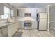 Renovated kitchen with stainless steel appliances, grey cabinets, and laminate flooring at 10816 Bent Branch Dr, Raleigh, NC 27603