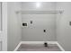 Functional laundry room with a shelf, gray walls, gray floors, and washer-dryer hookups at 10816 Bent Branch Dr, Raleigh, NC 27603
