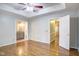 Bright main bedroom with hardwood floors, tray ceiling, and bathroom access at 10816 Bent Branch Dr, Raleigh, NC 27603