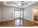 Bright main bedroom with hardwood floors, tray ceiling, and bay window at 10816 Bent Branch Dr, Raleigh, NC 27603
