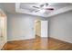 Spacious main bedroom with hardwood floors, tray ceiling, and closet at 10816 Bent Branch Dr, Raleigh, NC 27603
