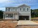 Two-story home with light gray siding, double garage, and covered front porch at 110 Cordoba Dr, Franklinton, NC 27525