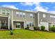 View of backyard with lush green grass, patio, vinyl fence, and the exterior of a two-story townhouse at 1156 Craigmeade Dr, Morrisville, NC 27560