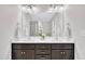 Bright bathroom featuring a double vanity with dark wood cabinets, ample lighting and neutral colored walls at 1156 Craigmeade Dr, Morrisville, NC 27560