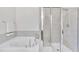 Bright bathroom featuring a soaking tub and glass enclosed shower with neutral tiling and trim at 1156 Craigmeade Dr, Morrisville, NC 27560