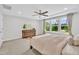 Relaxing bedroom with tray ceiling, ceiling fan, and dresser with a nature view from large windows at 1156 Craigmeade Dr, Morrisville, NC 27560