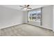 Empty bedroom featuring a ceiling fan, carpet and a window overlooking the town homes outside at 1156 Craigmeade Dr, Morrisville, NC 27560