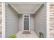 A cozy front entryway adorned with a decorative mat and framed by stone and neutral siding at 1156 Craigmeade Dr, Morrisville, NC 27560
