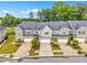 Street-level view of townhomes with attached garages, manicured lawns, and stone accents at 1156 Craigmeade Dr, Morrisville, NC 27560