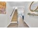 Inviting foyer featuring pristine hardwood floors, a staircase, and decorative wall accents at 1156 Craigmeade Dr, Morrisville, NC 27560