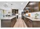 Well-appointed kitchen with granite countertops, stainless steel appliances, and dark wood cabinets, perfect for culinary enthusiasts at 1156 Craigmeade Dr, Morrisville, NC 27560