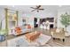 Open-concept living space with hardwood floors, modern furnishings, and a seamless flow to the kitchen at 1156 Craigmeade Dr, Morrisville, NC 27560