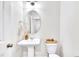 Bright powder room with pedestal sink, oval mirror, and decorative accents at 1156 Craigmeade Dr, Morrisville, NC 27560