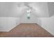 Spacious attic bedroom with neutral carpet, white walls, a ceiling fan, and multiple closets for storage at 119 Valleycastle Ct, Clayton, NC 27520