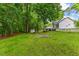 Green backyard with back of house, storage building and stairs leading to porch at 119 Valleycastle Ct, Clayton, NC 27520