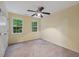 Bedroom with windows offering natural light, neutral carpet, and a ceiling fan creating a cozy and inviting room at 119 Valleycastle Ct, Clayton, NC 27520