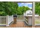 Outdoor kitchen and grilling station on the large deck with white railings at 119 Valleycastle Ct, Clayton, NC 27520