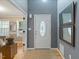 Bright foyer featuring a decorative front door, hardwood floors, and neutral wall colors at 119 Valleycastle Ct, Clayton, NC 27520