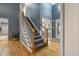 Inviting foyer with hardwood floors, a carpeted staircase, and ample natural light creating a warm entry at 119 Valleycastle Ct, Clayton, NC 27520