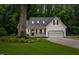 Charming white house featuring a well-maintained lawn, a two-car garage, and a cozy front porch at 119 Valleycastle Ct, Clayton, NC 27520