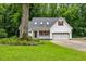 Charming white house featuring a well-maintained lawn, a two-car garage, and a cozy front porch at 119 Valleycastle Ct, Clayton, NC 27520
