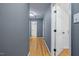 Hallway featuring freshly painted walls, beautiful hardwood floors, and ample lighting for a bright atmosphere at 119 Valleycastle Ct, Clayton, NC 27520