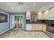 Bright kitchen with tile floors, light-colored cabinets, and stainless steel appliances, along with sliding glass doors at 119 Valleycastle Ct, Clayton, NC 27520