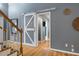 View of the living room with a barn door, hardwood floors, and access to other areas of the home at 119 Valleycastle Ct, Clayton, NC 27520