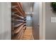 Custom walk-in closet with natural wood shelving, maximizing storage and adding warmth to the space at 119 Valleycastle Ct, Clayton, NC 27520
